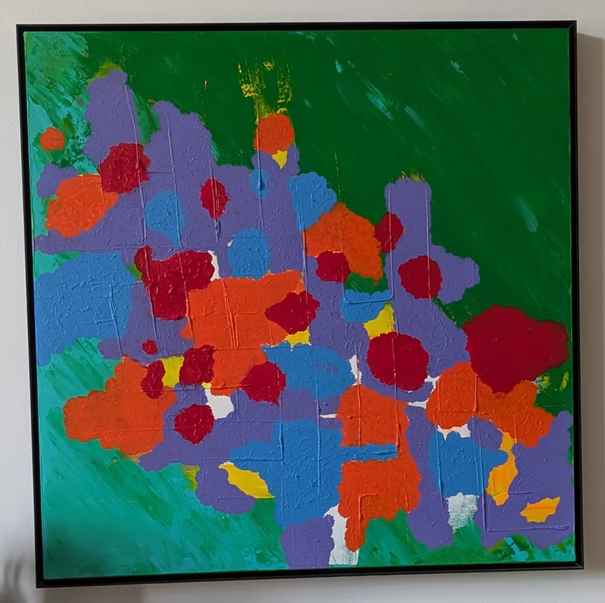 Abstract painting with purple, blue, orange, and red forms across a deep green field.