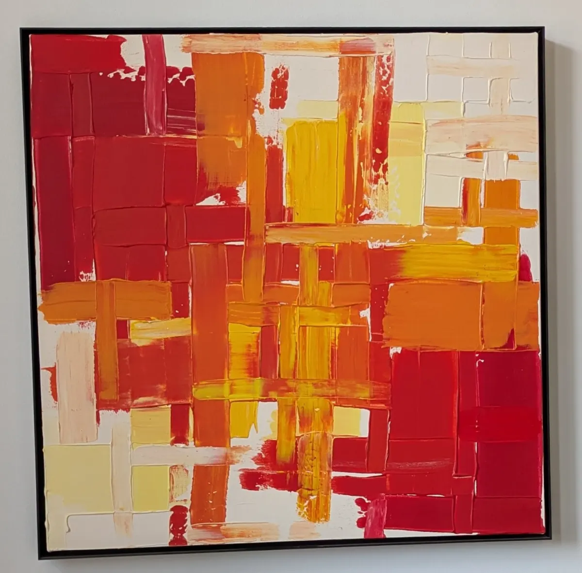 Abstract painting with interlocking red, orange, yellow, and cream brushstrokes.